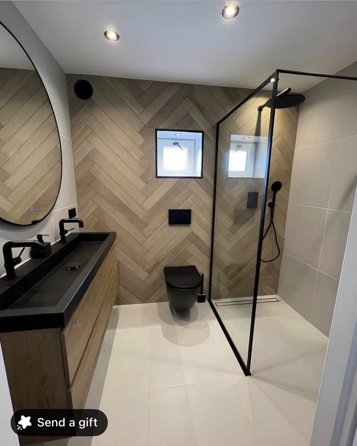 Modern wet room with herringbone wood-effect tiles, black fixtures and walk-in shower