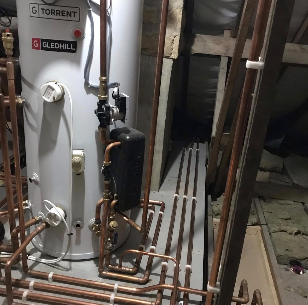 Gledhill Torrent unvented cylinder with pump, valves and copper manifold
